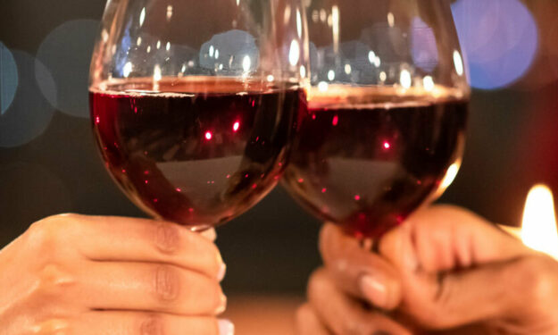 Two people holding wine glasses